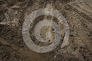 Wheel trail on sandy ground from large transport, tractor on construction site, sandy road