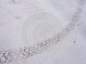 Wheel tread marks in the sand on the beach