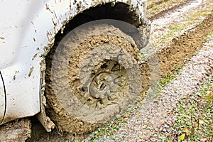 The wheel of a vehicle incased in mud