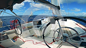 Wheel of a yacht is revolving by itself while sailing