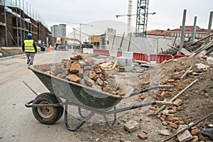 Wheelbarrow full of rubble at construction site