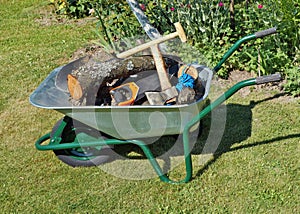 The wheelbarrow is on a garden lawn