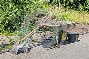 Wheelbarrow with gardening tools