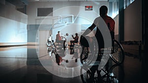 Wheelchair Basketball Game: Player Wearing Red Shirt Holding Ball Waiting for His Turn. Athlete Wa