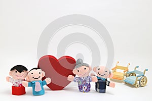 Wheelchair, a big red heart, and two-families on white background.