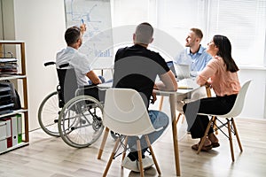 Wheelchair And Disability At Office. Giving Presentation photo