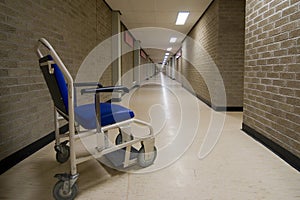 Wheelchair in an empty NHS hospital corridor