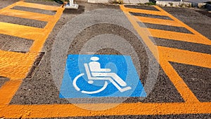 Wheelchair Handicap Sign on dark asphalt road street background- handicap parking place