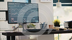 Wheelchair in inclusive office and business forecasting graphs on laptop