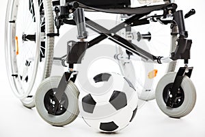 Wheelchair for invalid or disabled person and soccer ball