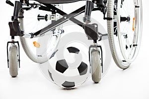 Wheelchair for invalid or disabled person and soccer ball