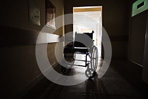 The wheelchair in the middle of an empty corridor in the hospital