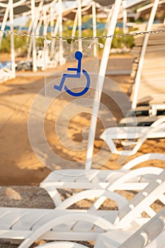Wheelchair sign showing the sunbeds reserved for disabled people