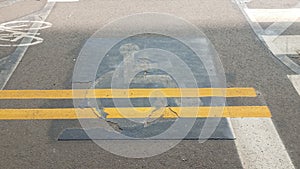 Wheelchair sign with yellow lines painted over