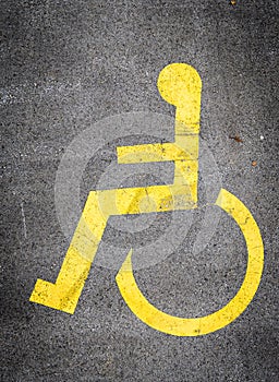 Wheelchair symbol in a Parking Lot marks disabled parking space.