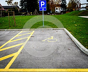 Wheelchair symbol in a Parking Lot marks disabled parking space.