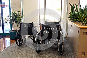 Wheelchairs with Cancer Center on back in waiting room