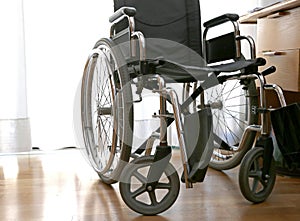 Wheelchairs to disabled people in a bedroom