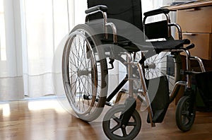 Wheelchairs to disabled people in a bedroom