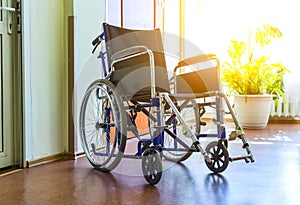 Wheelchairs to disabled people in room with parquet floor