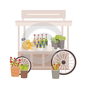 Wheeled cart, marketplace or counter with cheese, bottles and price tags. Place for selling food products on local