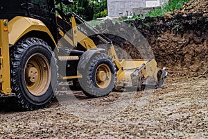 Wheeled loader excavator with backhoe for earthmoving works