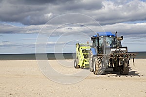 Wheeled tractor for cleaning sand on beach