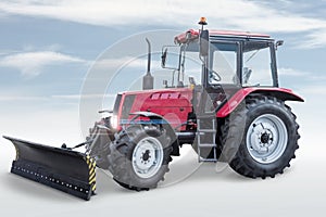 Wheeled tractor with mouldboard isolated on bright background with sky