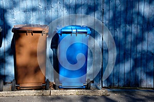 Wheelie bin colour blue, purple and black for refuge collection outside house in a row