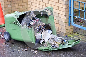 Wheelie bin vandalism on side burnt out by fire by vandals in council estate London arson attack