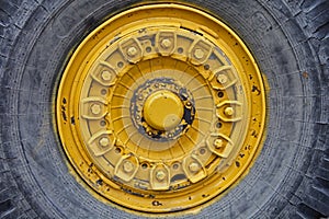 Wheels background. Some details from a large yellow ore hauler called Belaz