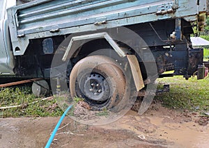 The wheels of the car got stuck in the mud when it rains. During the day