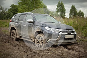 The wheels of the car are stuck in the mud. Off-road driving.