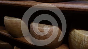 Wheels of cheese on the racks of a maturing cave