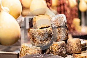 Wheels of cheese seasoned in the local christmas market stall, Pecorino cheese, Parmesan, Provolone