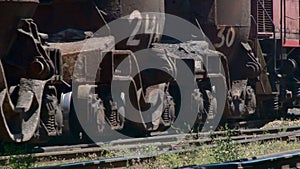 Wheels of a freight train traveling slowly on rails