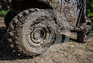 Wheels of off road car stuck full of mud