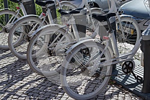 Wheels of parked bikes in the bike rental parking lot. Bicycle rental point. Bicycle rental is inexpensive. Bicycle