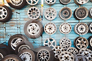 Wheels and tires on the wall in the car dealership.