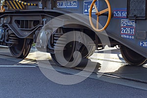 Wheels of a train passing through a railway crossing, close-up