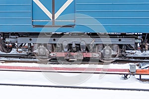 Wheelset near a subway car with a pantograph on a contact rail in winter