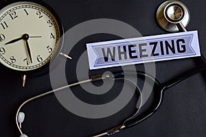 Wheezing on the paper with Healthcare Concept Inspiration. alarm clock, Black stethoscope.