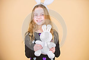 Where did Easter rabbit come from. Little girl holding Easter rabbit toy. Happy child playing with Easter bunny rabbit