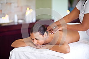 This is where I come to relax. a young woman enjoying a back massage at a spa.