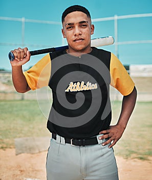 This is where I want to be. a young baseball player holding a baseball bat while posing outside on the pitch.