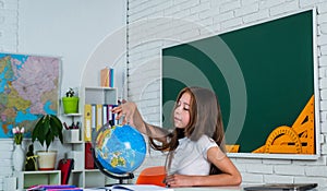 where to go. back to school. teen girl work in classroom near blackboard. cheerful kid learning geography. modern