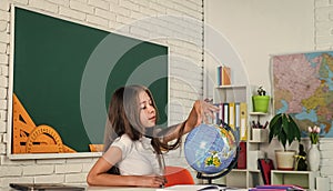 where to go. back to school. teen girl work in classroom near blackboard. cheerful kid learning geography. modern