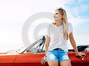 Where will the road take me this time. a happy young woman enjoying a summers road trip.