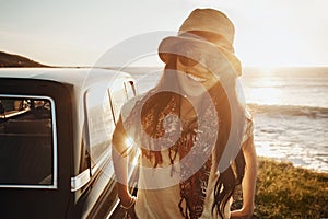 This is where youll find me when its sunny out. Portrait of a young woman enjoying a road trip along the coast.