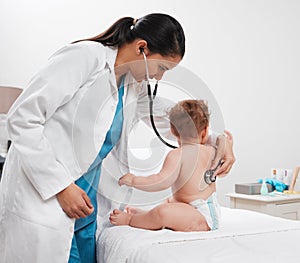 Whered she go. Shot of a paediatrician examining a baby in a clinic.